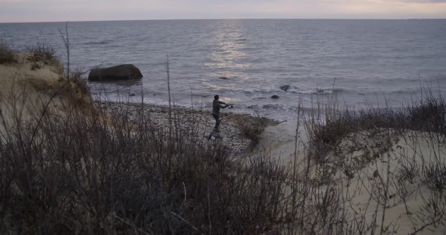 A person is fishing at a lake