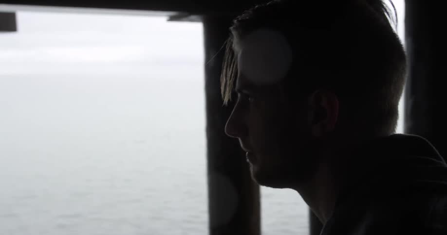 A  man is leaving his window