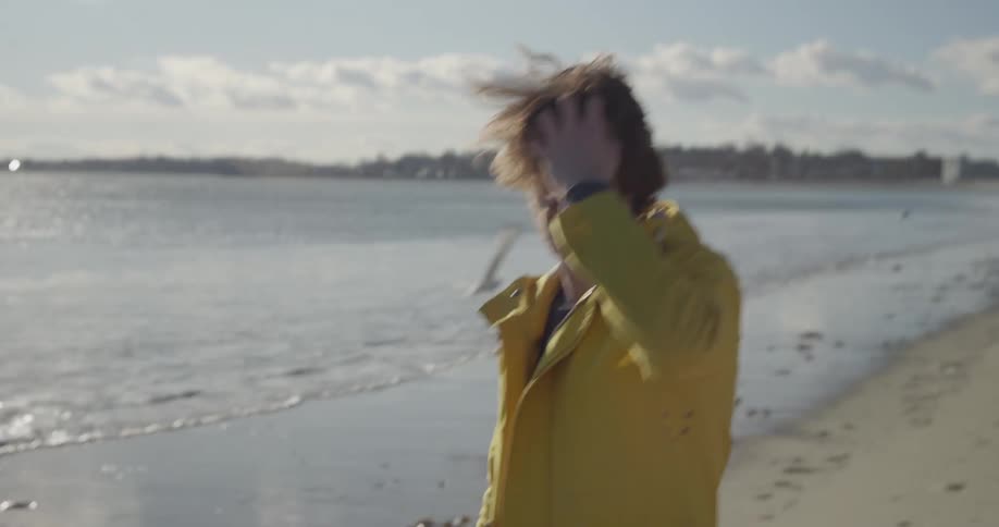A person wearing a yellow coat