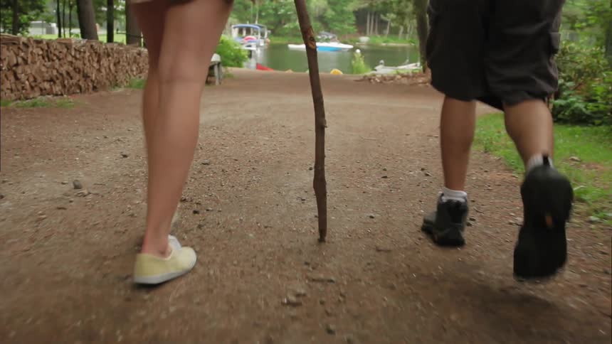People are hiking toward a lake