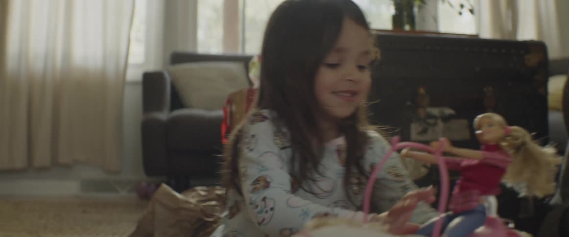 Child plays with a toy pony and a doll