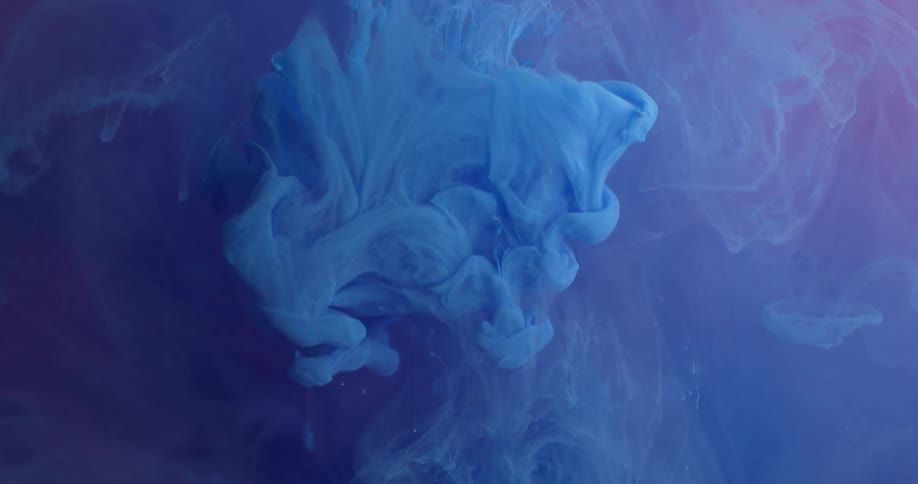 Blue dye is pouring into and spreading out in a liquid solution