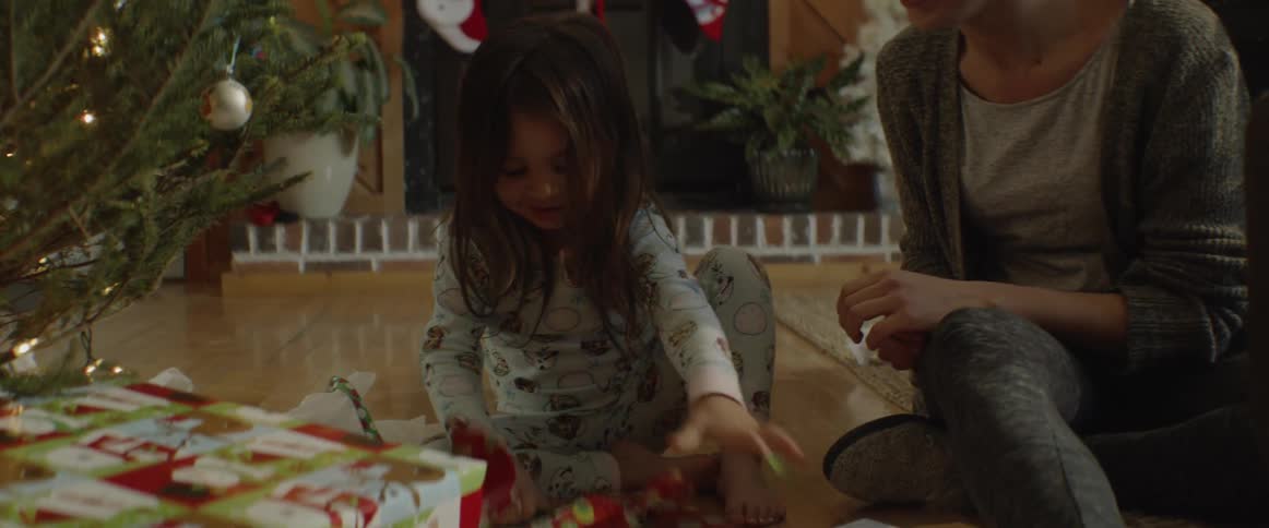 A family is opening up christmas presents together