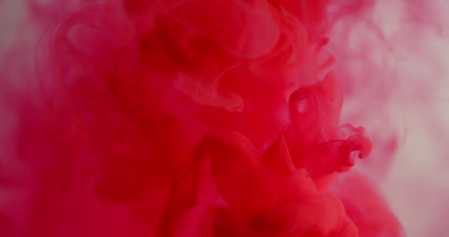 Red liquid mixes into clear liquid