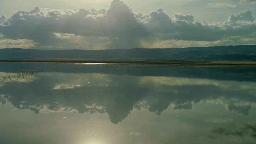 Reflections of clouds on smooth lake water