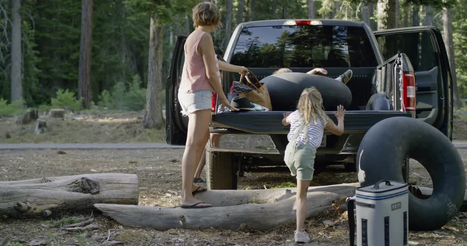 Children play in the bed of a truck