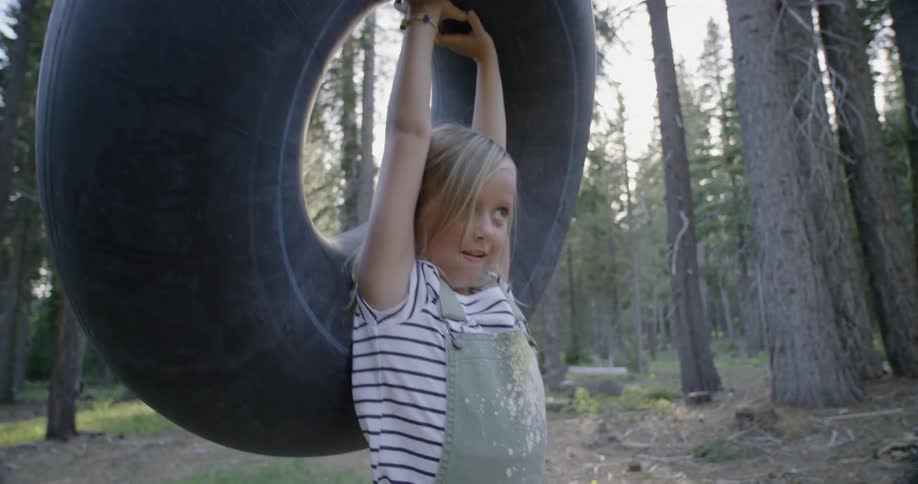 A girl holds a river tube over her head