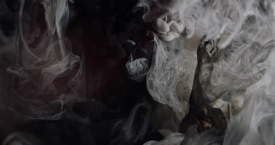 Clouds of white and gray expand and sink in liquid