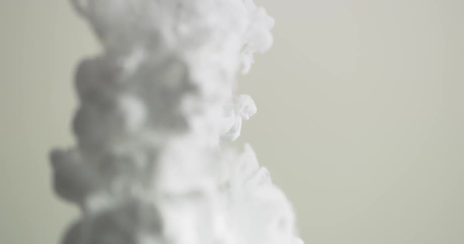White liquid flows and swirls underwater
