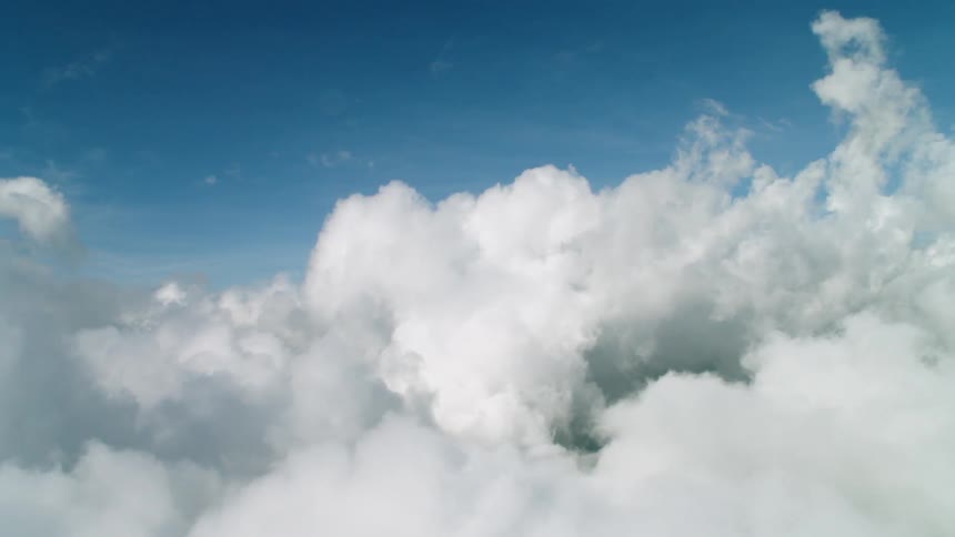 Fluffy white clouds floating in the blue sky