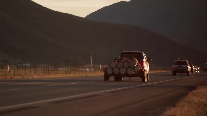 A truck travels down the road transporting lumber