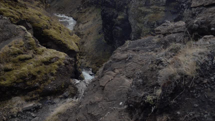 A river is running through a gorge in daylight