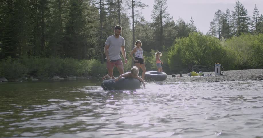 A boy floats on a tube on a river