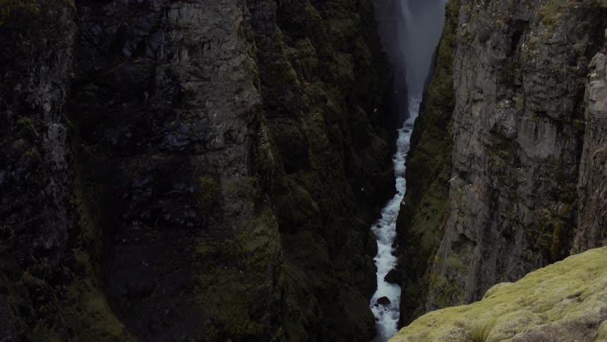 The birds fly around the crevice in the mountain