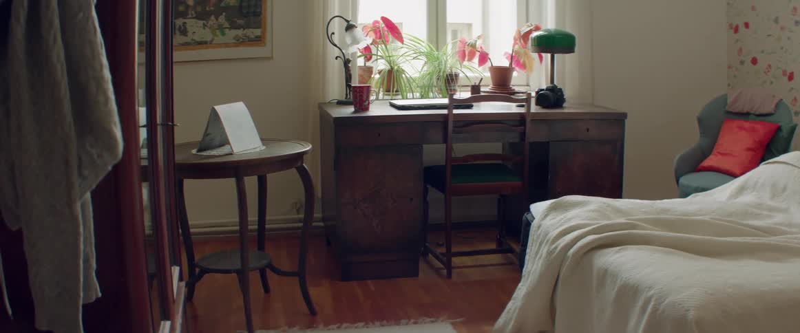 A view of a neat home workspace featuring a wooden desk and chair.