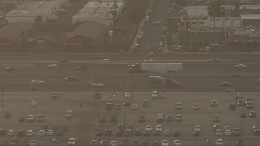 Cars drive on a city street