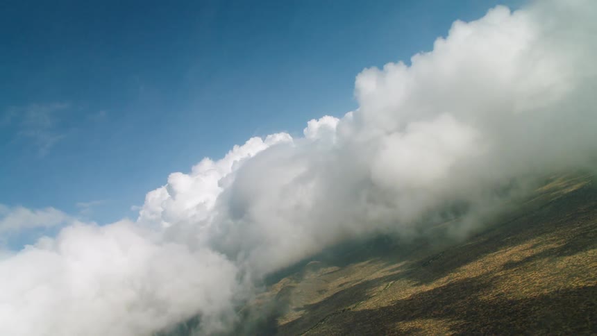 Moving through fluffy clouds hovering over the fields below