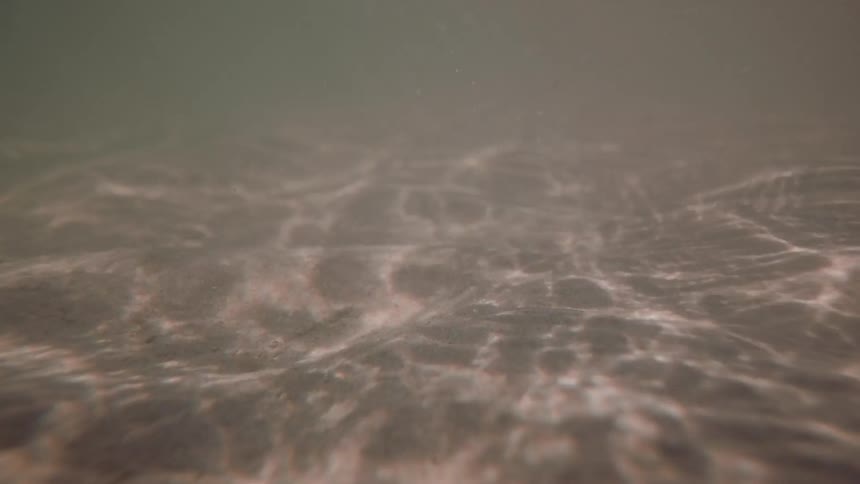 Light reflections on underwater sand