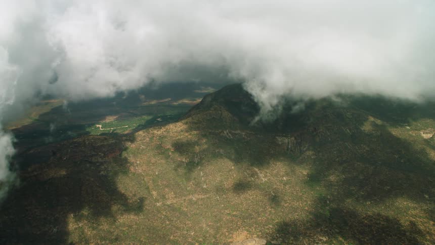 Thick clouds throw shadow over mountains