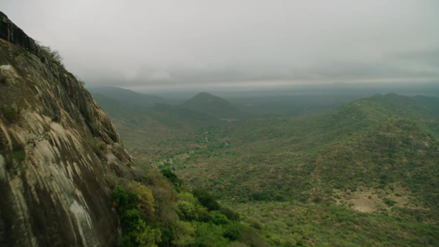 Clouds are hanging over a tropical landscape during the day