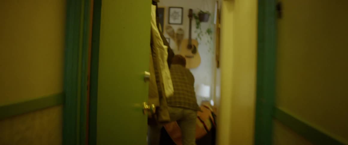 Man running through hallway in house then jumping out window