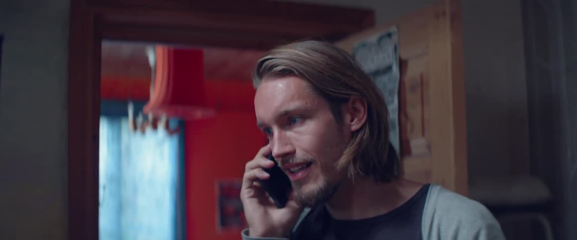 A concerned man opens his mouth to speak during an intense call.