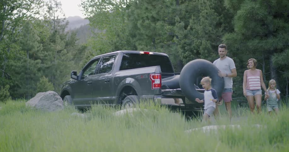 A family unload inner tubes from the truck