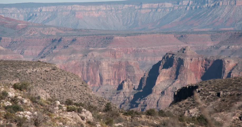 The sun shines on canyon ridges and walls