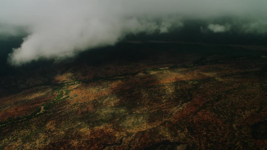 Clouds are hanging low over a valley