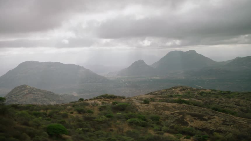 Sun shines through clouds over the mountains