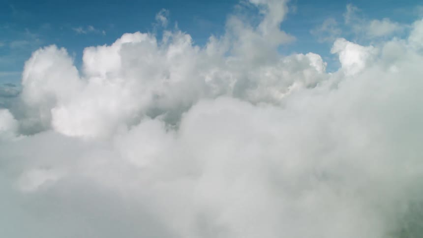 Fluffy white clouds in a blue sky