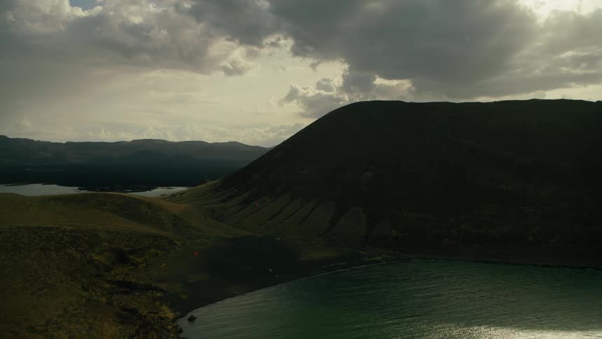 Cloudy skies over some mountains and sea