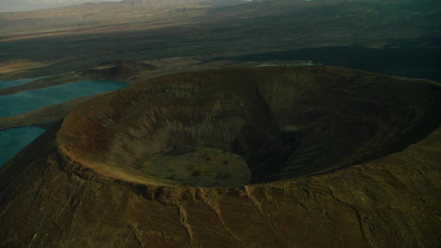 A large crater sits in the middle of a lake
