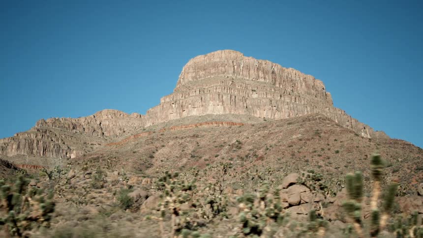 A plateau is rising through the desert into the sky