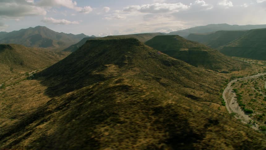 Clouds hang above the mountain landscape