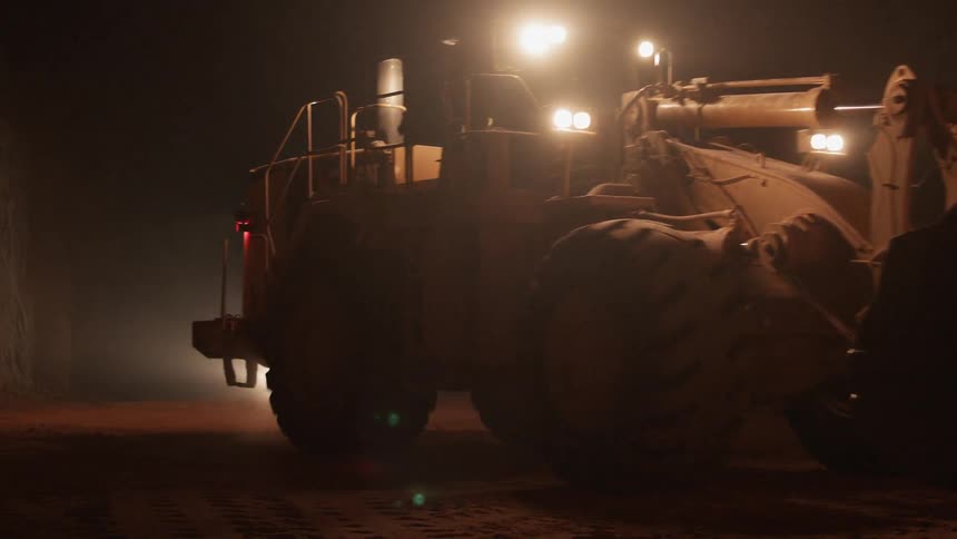 Tractor rolls over dirt at night