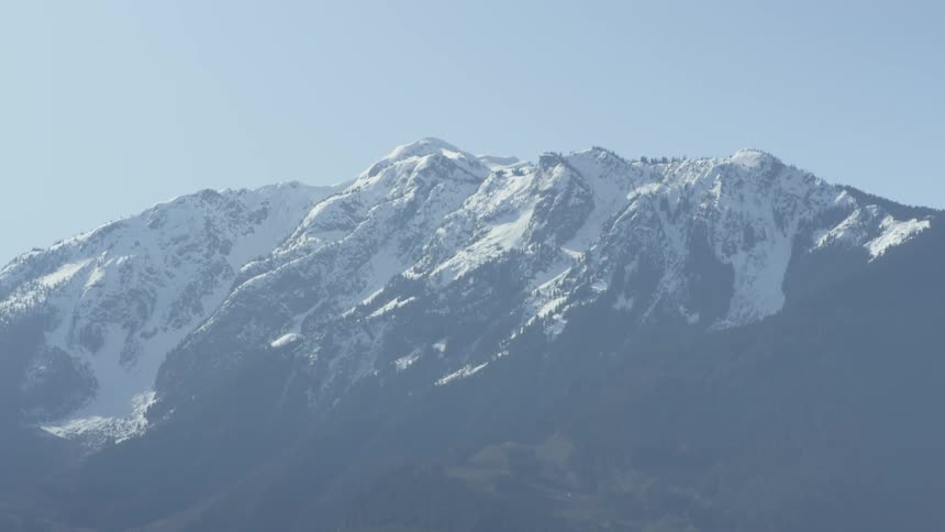 Snow covers the top of the mountain