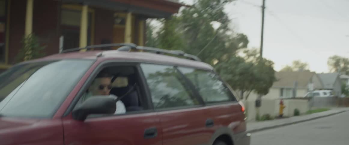 A young man flees through a neighborhood