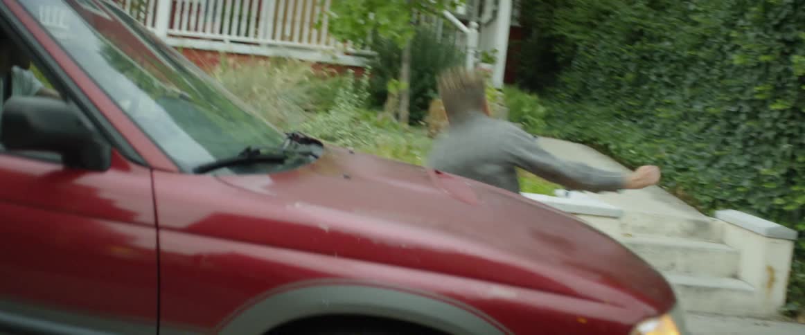 Man runs into moving car then gets up and continues running