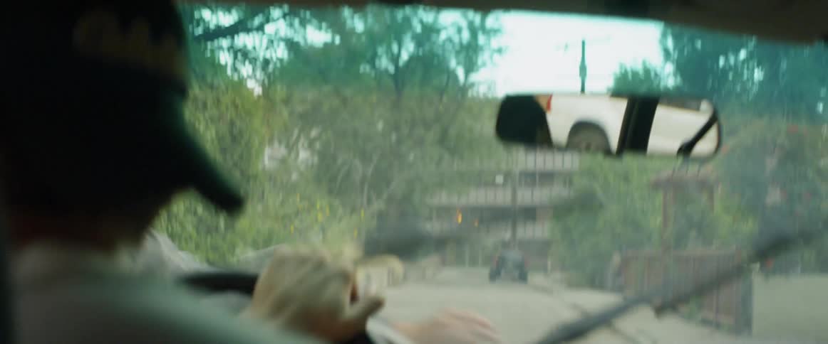Man driving a car slams on the brakes as he hits another man