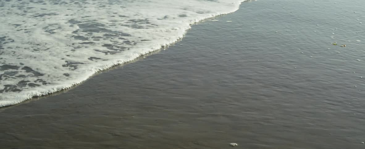 The small waves crashes into the sand