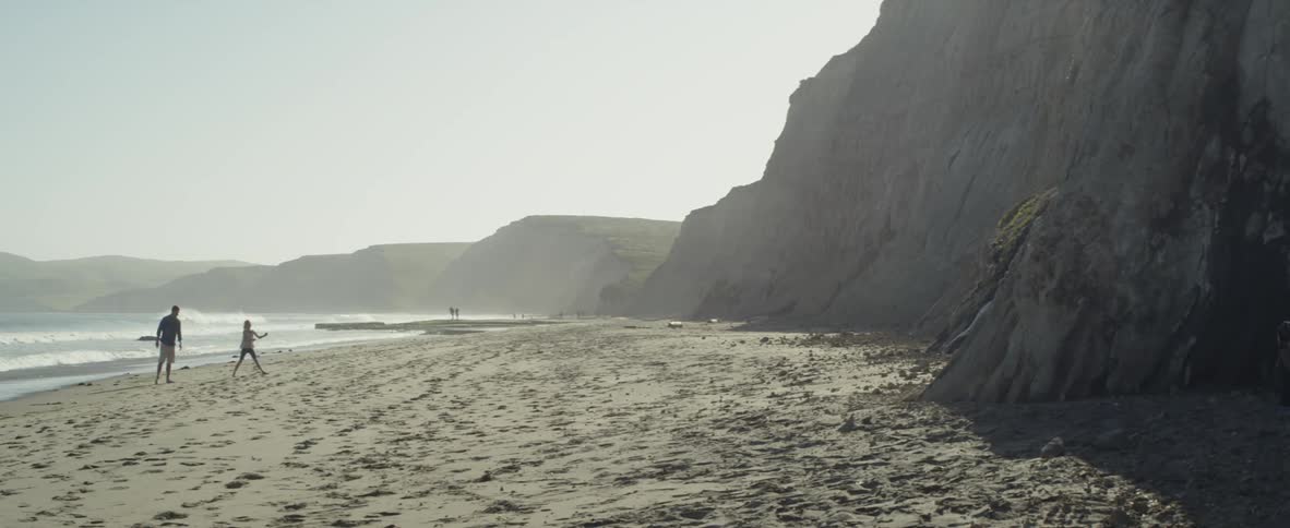 People walk and play on the beach