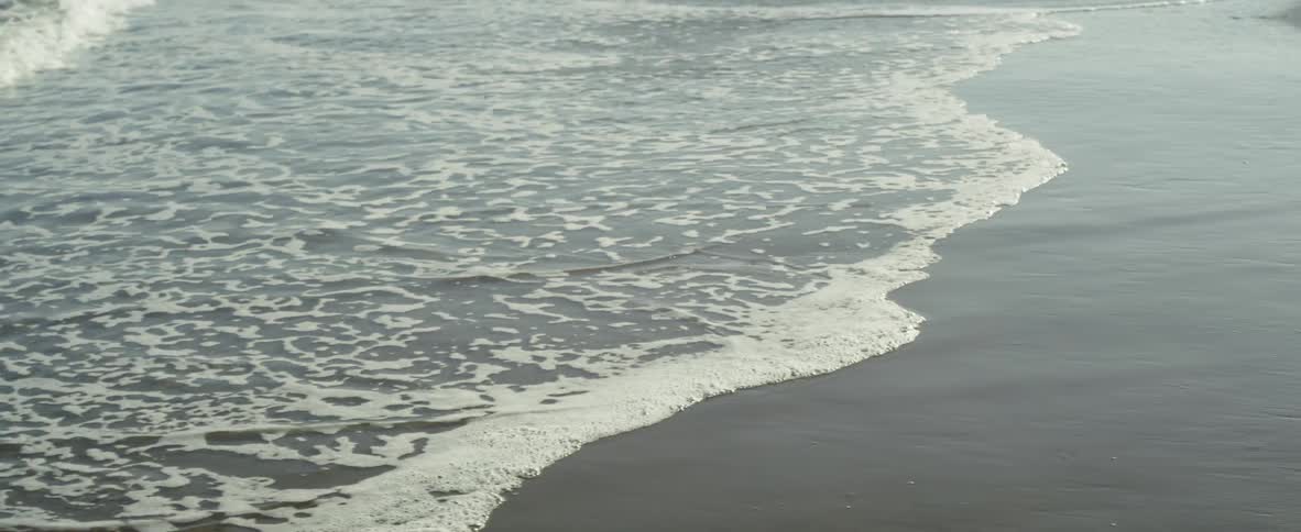 Ocean water washing onto sandy shore