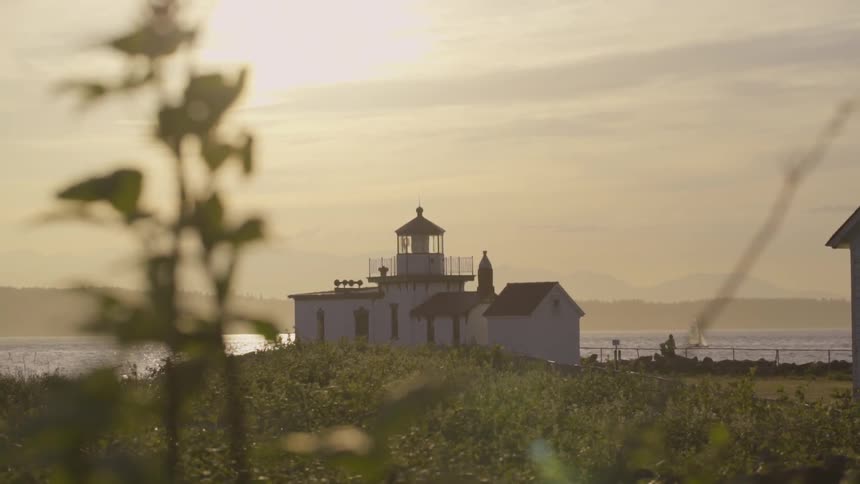 A lighthouse stands near the ocean