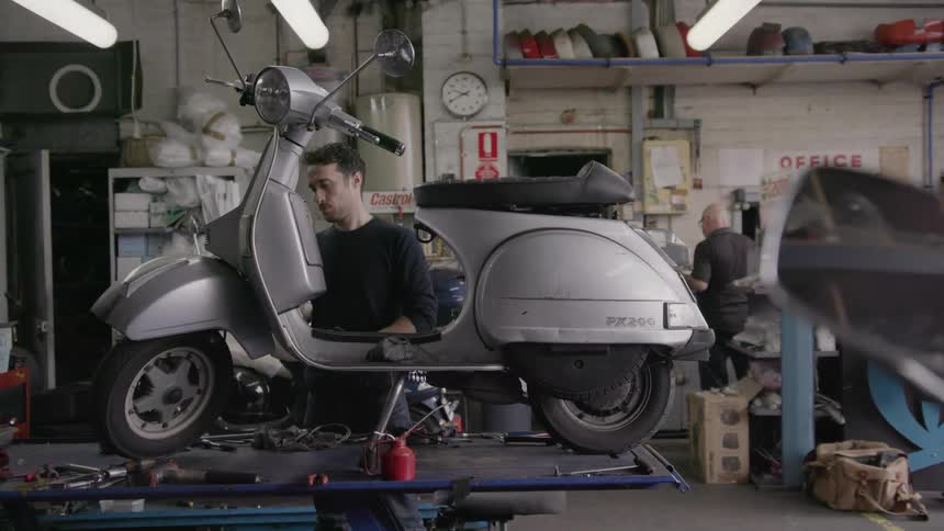 Man fixes a small motorbike