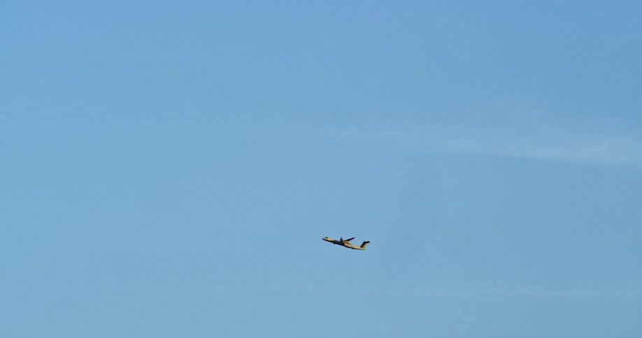Airplane takes off into the wide blue sky