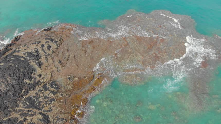 Ocean waves crash into a shoreline