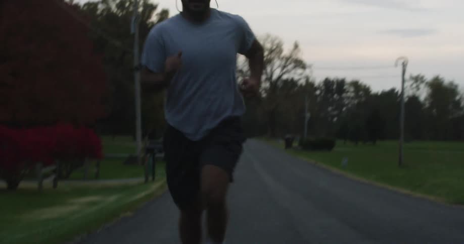 Person jogs down a country road