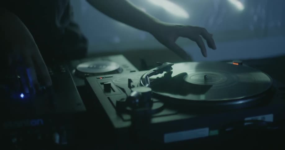 A dj works the turntable and dances