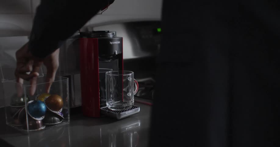 A man brews a cup of coffee